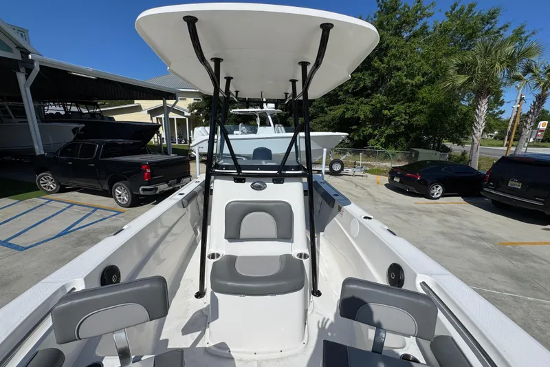 Slide: The Image of 2027 Sea Born LX21 Center Console boat in a parking lot, showcasing seating and T-top. - 20