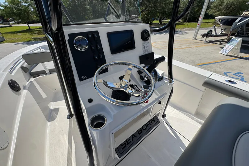 Slide: The Image of 2027 Sea Born LX21 Center Console boat interior with steering wheel and control panel. - 26
