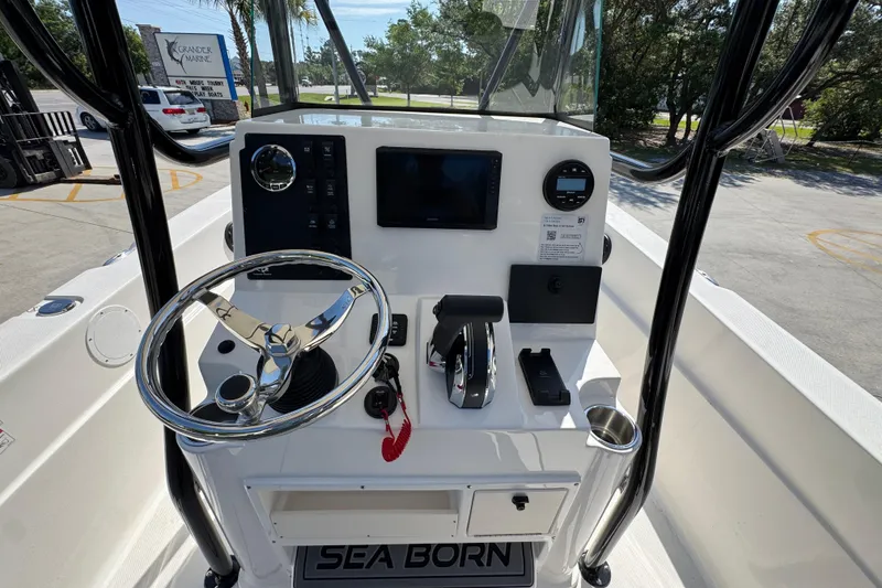 Slide: The Image of 2027 Sea Born LX21 Center Console boat dashboard with steering wheel and controls. - 27