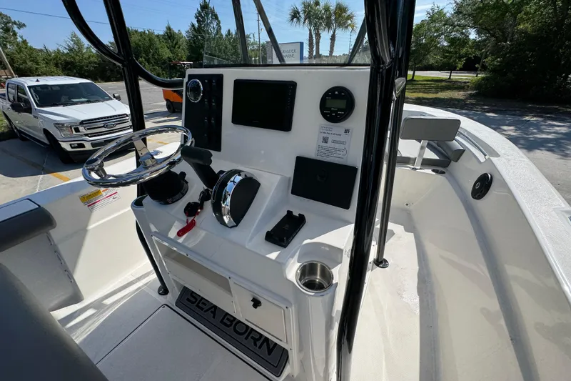 Slide: The Image of 2027 Sea Born LX21 Center Console boat interior with steering wheel and controls. - 28