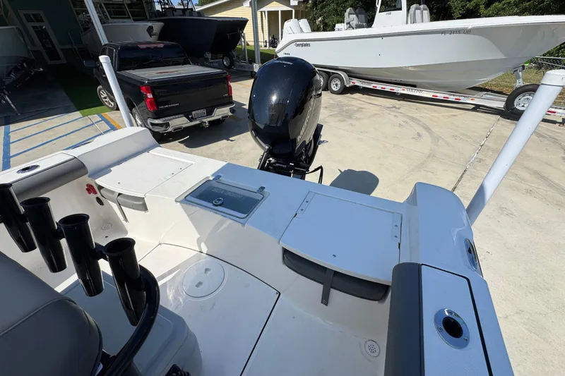 Slide: The Image of 2027 Sea Born LX21 Center Console boat with outboard motor in a marina setting. - 29