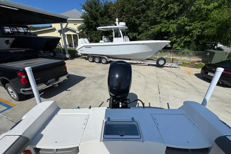 Slide: The Image of 2027 Sea Born LX21 Center Console boat parked near vehicles in a sunny lot. - 30