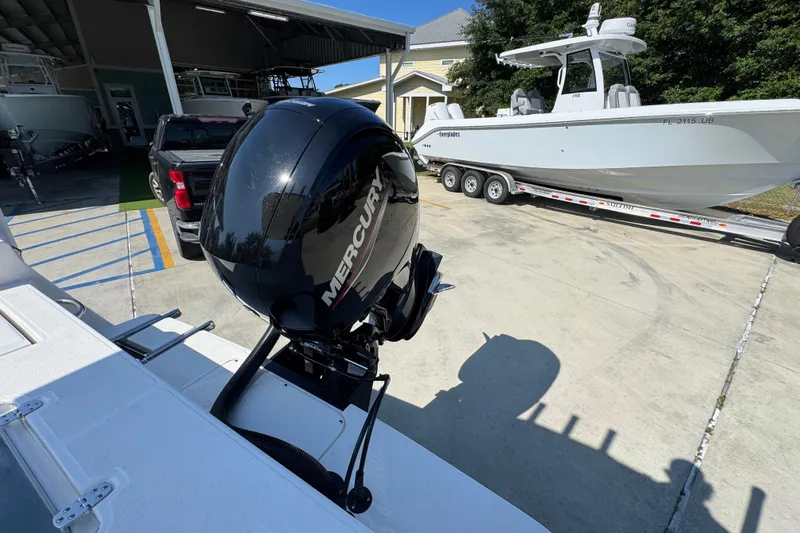 Slide: The Image of 2027 Sea Born LX21 Center Console with Mercury outboard motor in a marina setting. - 31