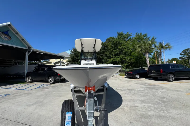 Slide: The Image of 2027 Sea Born LX21 Center Console boat on trailer in sunny parking lot. - 5