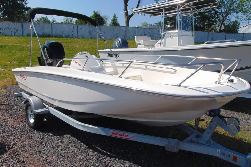 The Image of 2026 Boston Whaler 160 Super Sport boat on trailer, parked outdoors. - 1