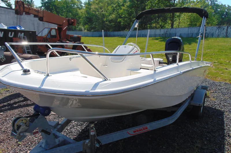 Slide: The Image of 2026 Boston Whaler 160 Super Sport boat on trailer, parked outdoors. - 3