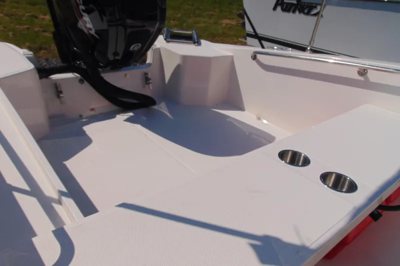 Slide: The Image of 2026 Boston Whaler 160 Super Sport boat interior with motor and cup holders. - 6