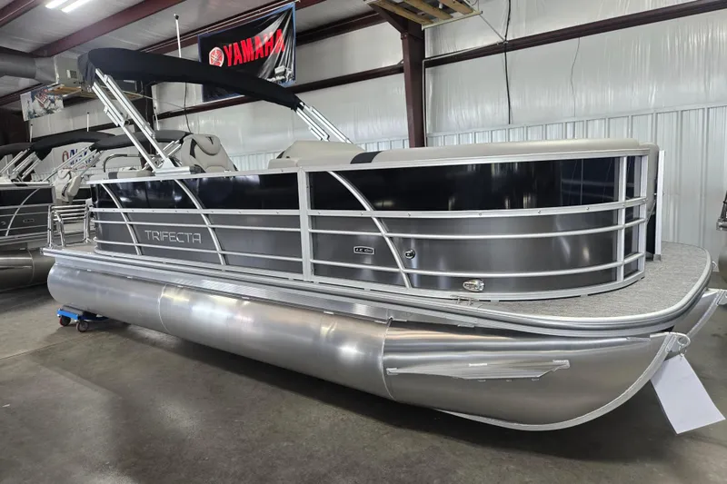 The Image of 2025 Trifecta 20RF LE pontoon boat in showroom, featuring sleek design and modern amenities. - 1