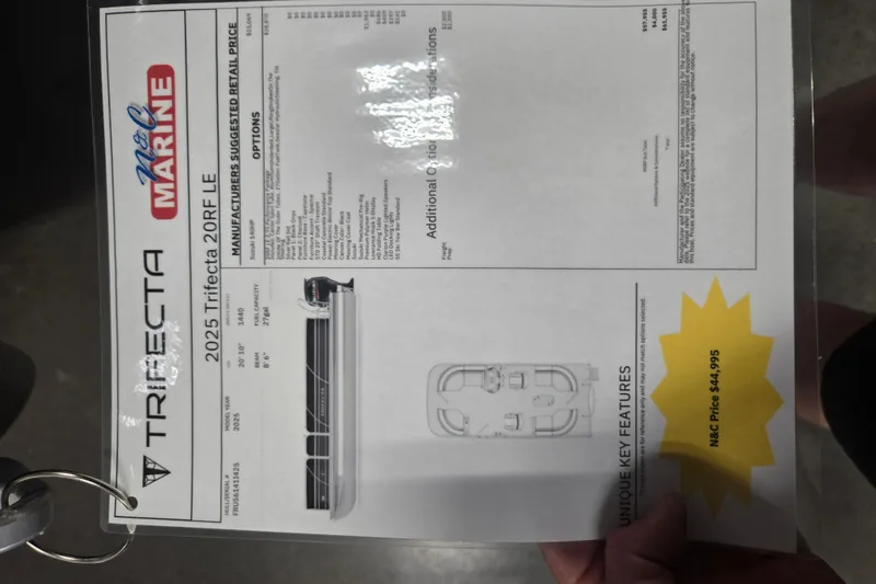 Slide: The Image of 2025 Trifecta 20RF LE boat specifications and pricing sheet displayed at a marine dealership. - 11