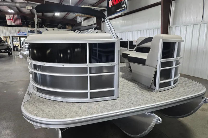 Slide: The Image of 2025 Trifecta 20RF LE pontoon boat in showroom, featuring sleek design and comfortable seating. - 12