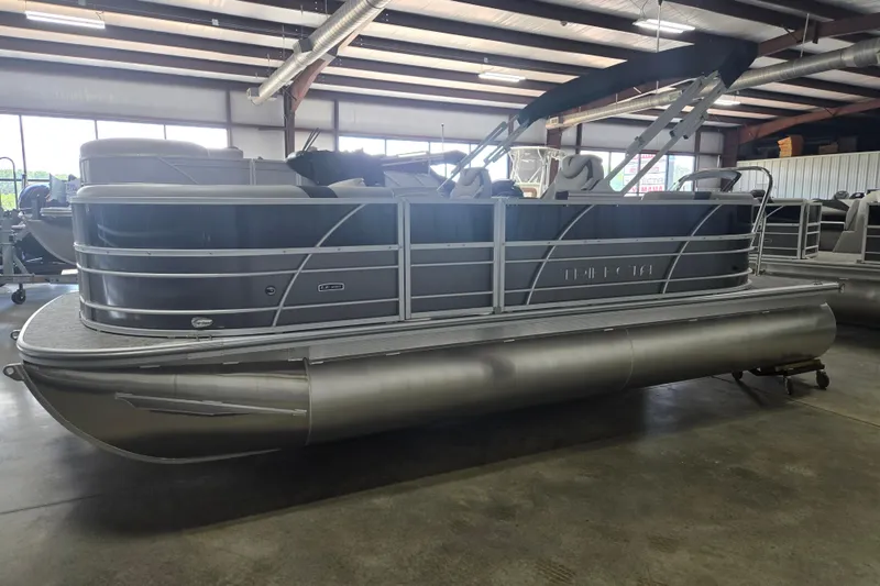 Slide: The Image of 2025 Trifecta 20RF LE pontoon boat in a showroom, showcasing sleek design and modern features. - 4