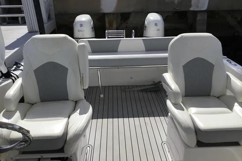 Slide: The Image of 2020 Twin Vee 240 DC GF boat interior with dual seats and Suzuki engines. - 15