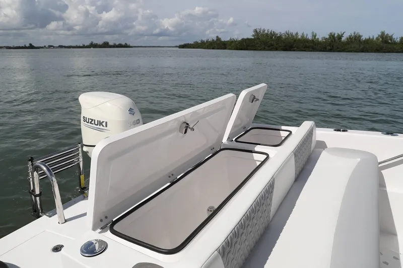 Slide: The Image of Manufacturer Provided Image: 2020 Twin Vee 240 DC GF boat with open storage compartments and Suzuki outboard motor. - 16