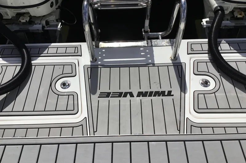 Slide: The Image of 2020 Twin Vee 240 DC GF boat deck with sleek design and branding. - 17