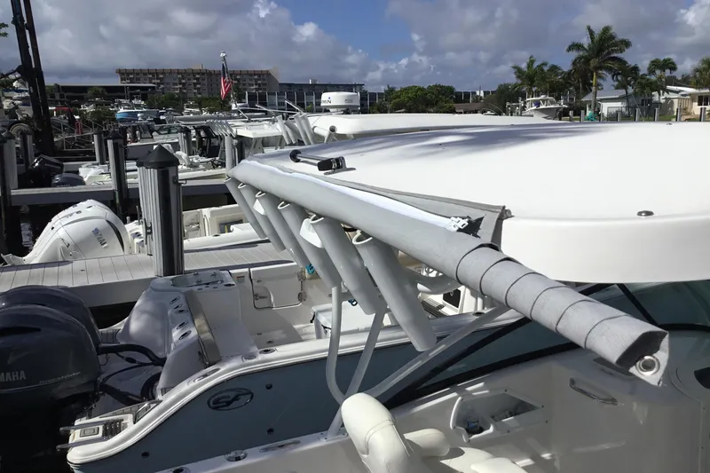 Slide: The Image of 2020 Twin Vee 240 DC GF boat docked at marina under cloudy sky. - 18