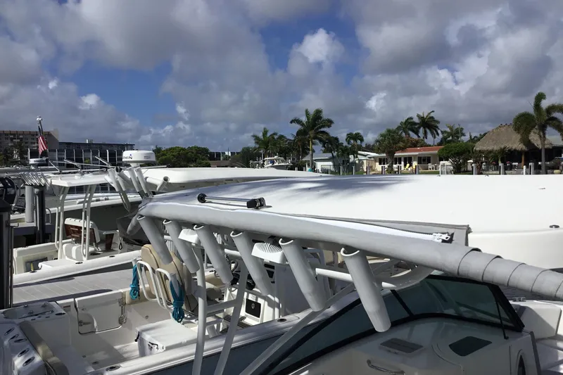 Slide: The Image of 2020 Twin Vee 240 DC GF boat docked at marina under cloudy sky. - 19