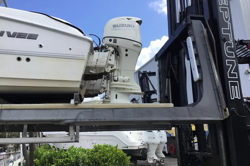 Slide: The Image of 2020 Twin Vee 240 DC GF boat with Suzuki outboard motor on forklift. - 22
