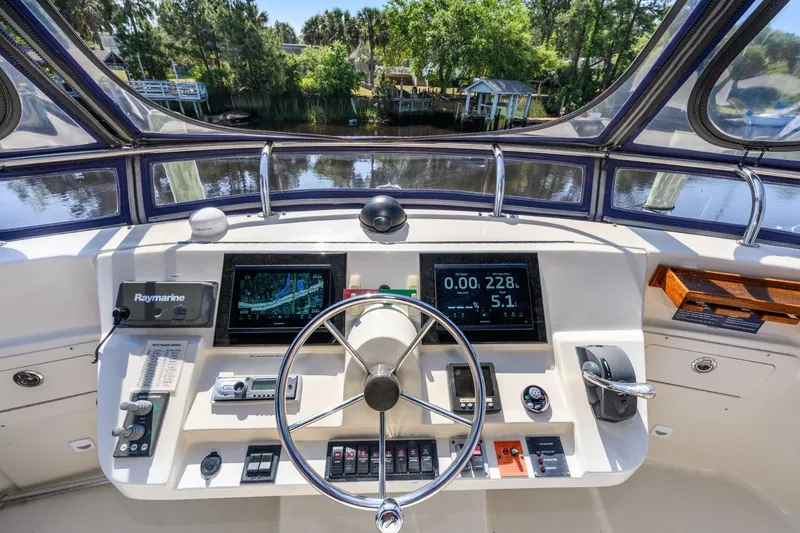 Slide: The Image of Helm of 2009 Mainship 40 Expedition with navigation equipment and scenic waterway view. - 24