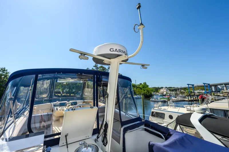 Slide: The Image of 2009 Mainship 40 Expedition yacht with Garmin radar, docked at a marina under clear blue skies. - 35