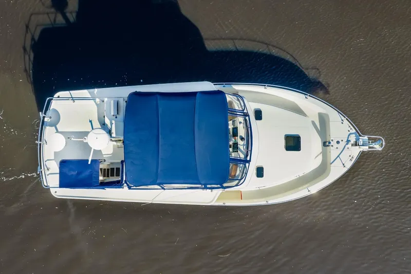 Slide: The Image of Aerial view of 2009 Mainship 40 Expedition boat with blue canopy on water. - 10
