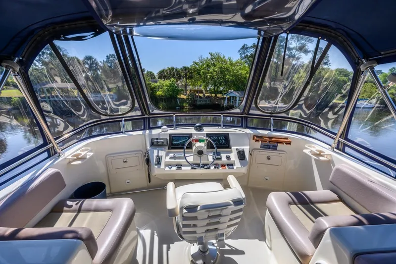 Slide: The Image of 2009 Mainship 40 Expedition yacht helm with panoramic windows and modern controls. - 32