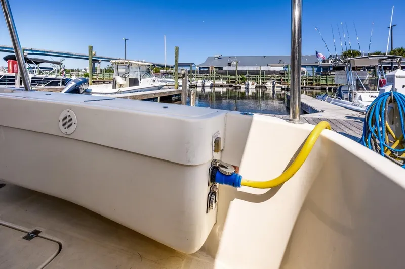 Slide: The Image of 2009 Mainship 40 Expedition docked, showing power connection and marina background. - 39