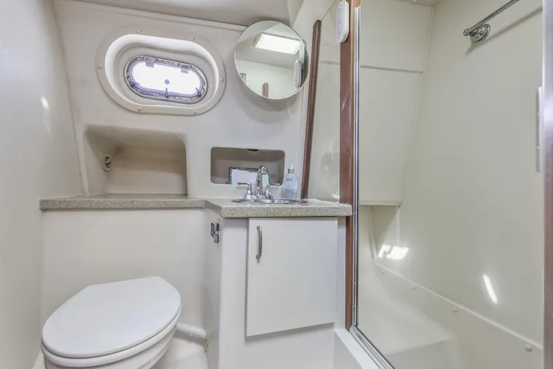Slide: The Image of 2009 Mainship 40 Expedition yacht bathroom with shower, sink, and porthole window. - 29