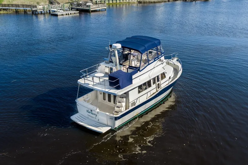 Slide: The Image of 2009 Mainship 40 Expedition yacht cruising on calm waters. - 8