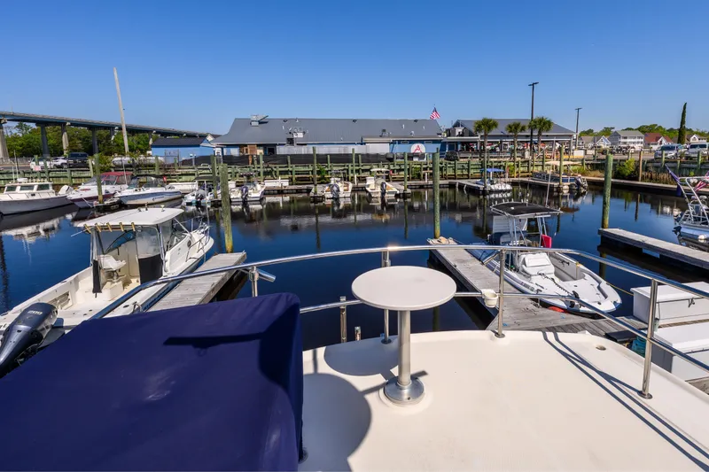Slide: The Image of Marina view from 2009 Mainship 40 Expedition yacht, showcasing docked boats and clear blue sky. - 18
