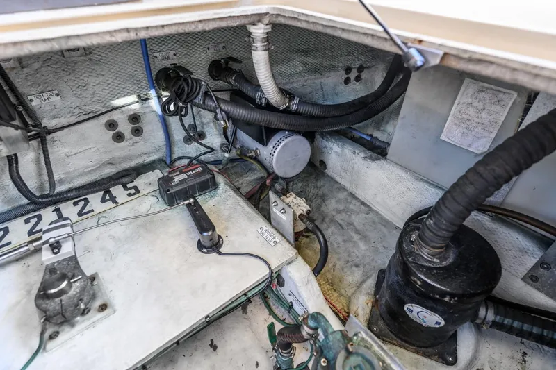 Slide: The Image of Engine compartment of 2009 Mainship 40 Expedition boat, showcasing mechanical components and wiring. - 26