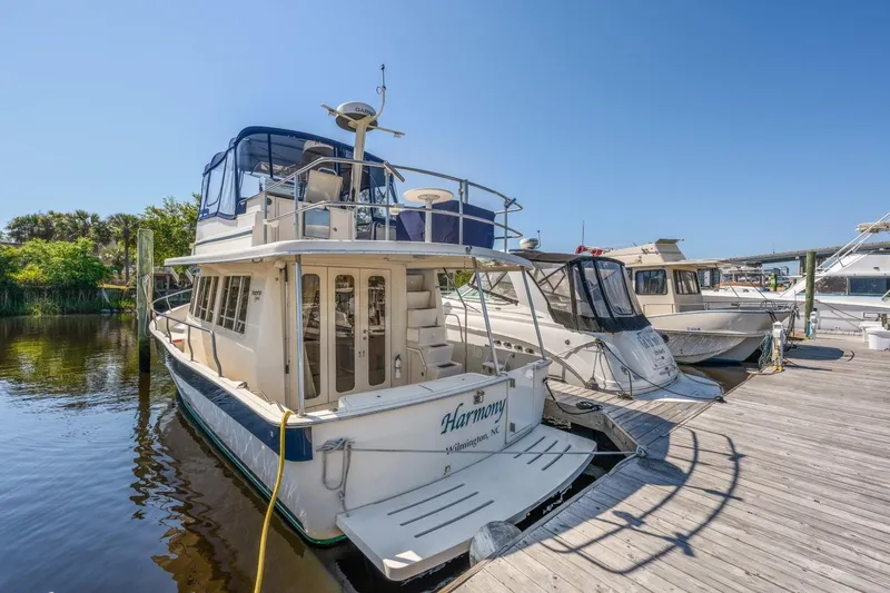 Slide: The Image of 2009 Mainship 40 Expedition docked at marina under clear blue sky. - 12