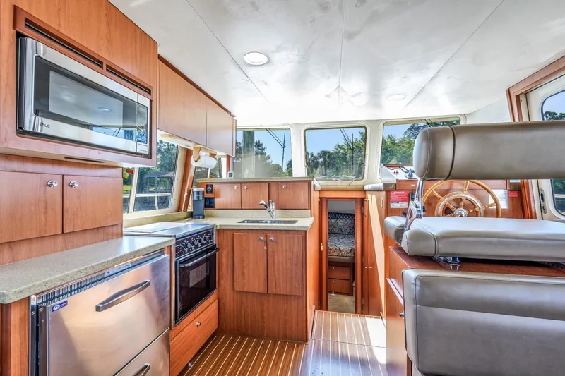 Slide: The Image of 2009 Mainship 40 Expedition yacht interior with modern kitchen and helm station. - 38