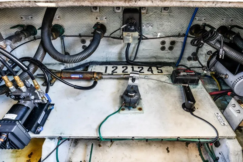 Slide: The Image of Engine compartment of a 2009 Mainship 40 Expedition boat, showing mechanical components and wiring. - 21