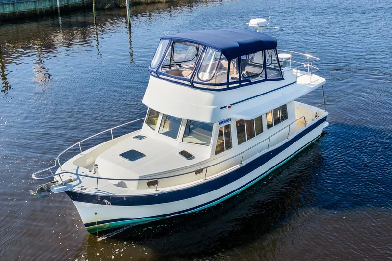 Slide: The Image of 2009 Mainship 40 Expedition yacht cruising on calm waters. - 2
