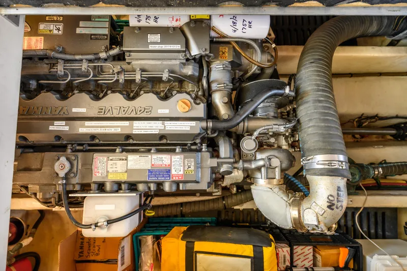 Slide: The Image of Engine compartment of a 2009 Mainship 40 Expedition boat, showcasing detailed mechanical components. - 27