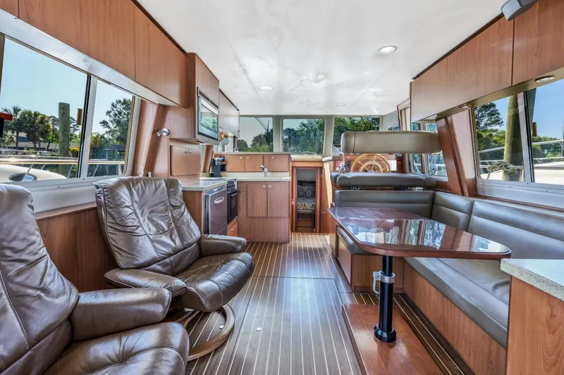 Slide: The Image of Luxurious interior of 2009 Mainship 40 Expedition yacht with leather seating and wooden finishes. - 19