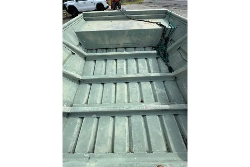 Slide: The Image of 1992 Weldcraft 1648 boat interior with metal flooring and storage compartment. - 5