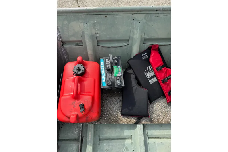 Slide: The Image of Red fuel tank, battery, and life jackets in a 1992 Weldcraft 1648 boat. - 9