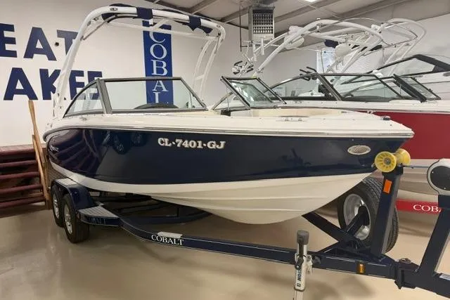 The Image of 2017 Cobalt 200S boat on trailer in showroom, blue and white exterior. - 0