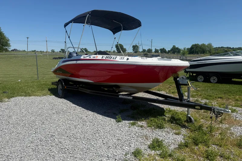 Slide: The Image of 2020 Hurricane SunDeck Sport 185 OB boat on trailer, parked on gravel. - 3