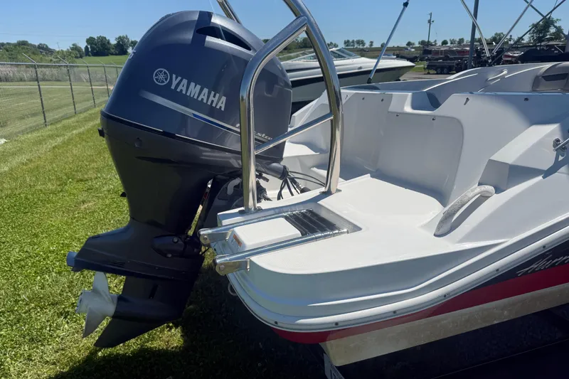 Slide: The Image of 2020 Hurricane SunDeck Sport 185 OB boat with Yamaha outboard motor, docked on grass. - 5