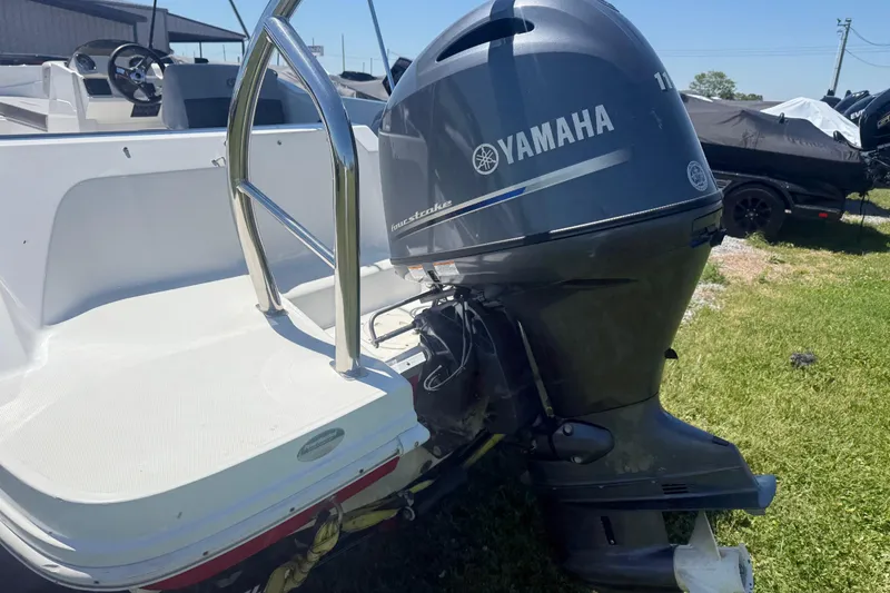 Slide: The Image of 2020 Hurricane SunDeck Sport 185 OB with Yamaha outboard motor on grassy area. - 6