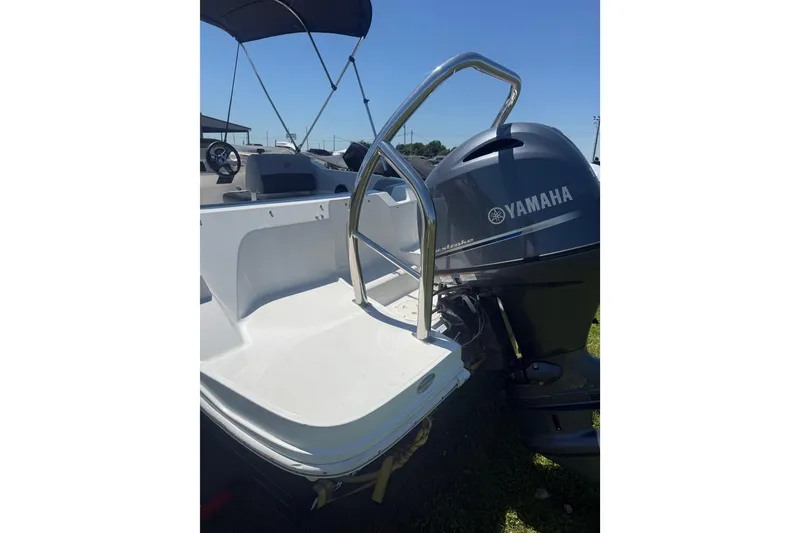 Slide: The Image of 2020 Hurricane SunDeck Sport 185 OB boat with Yamaha outboard motor, featuring a sleek design. - 7