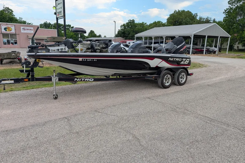 The Image of 2011 Nitro Z-8 boat on trailer, parked outdoors near a dealership. - 37