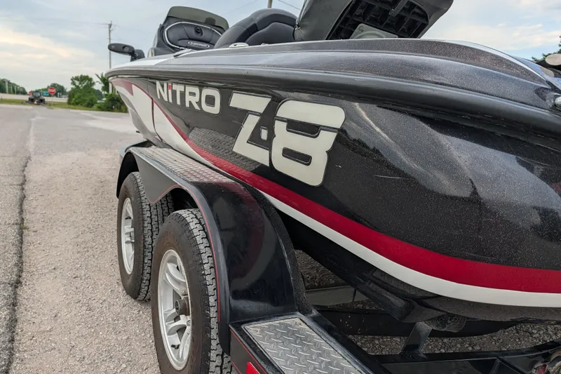 Slide: The Image of 2011 Nitro Z-8 boat on trailer, parked roadside, showcasing sleek design and branding. - 40