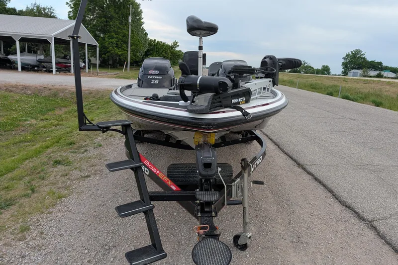 Slide: The Image of 2011 Nitro Z-8 boat on trailer, featuring Minn Kota trolling motor, parked outdoors. - 46
