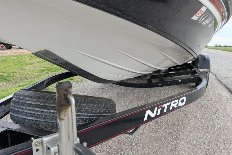 Slide: The Image of 2011 Nitro Z-8 boat on trailer, close-up view of hull and tire. - 48