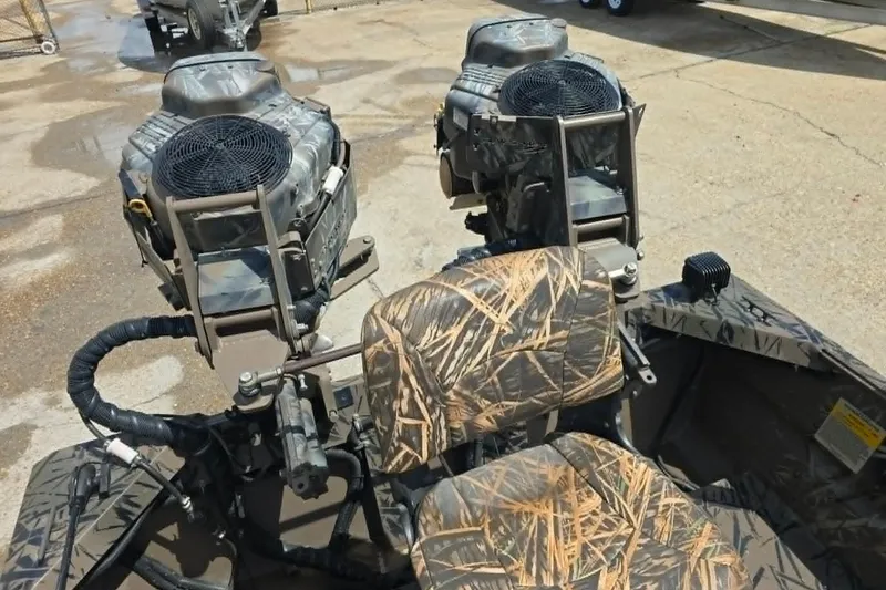 Slide: The Image of 2021 Prodrive 2060 boat with dual engines and camo seating on concrete surface. - 12