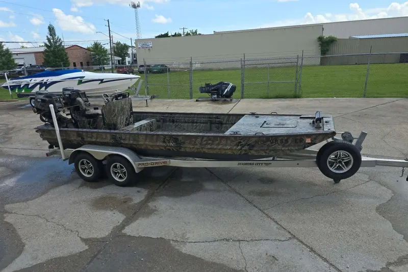 Slide: The Image of Prodrive 2060 boat on trailer, 2021 model, parked outdoors on concrete surface. - 3