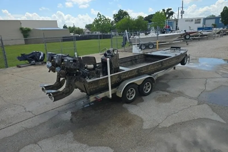 Slide: The Image of 2021 Prodrive 2060 boat on trailer, dual motors, parked in industrial area. - 5